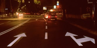 Samochody oczekujące na sygnalizacji świetlnej po zmroku
