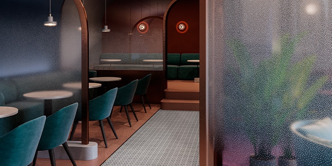 Wnętrze restauracji ze szklanymi ściankami wykończonymi kropkowaną folią 3M.
